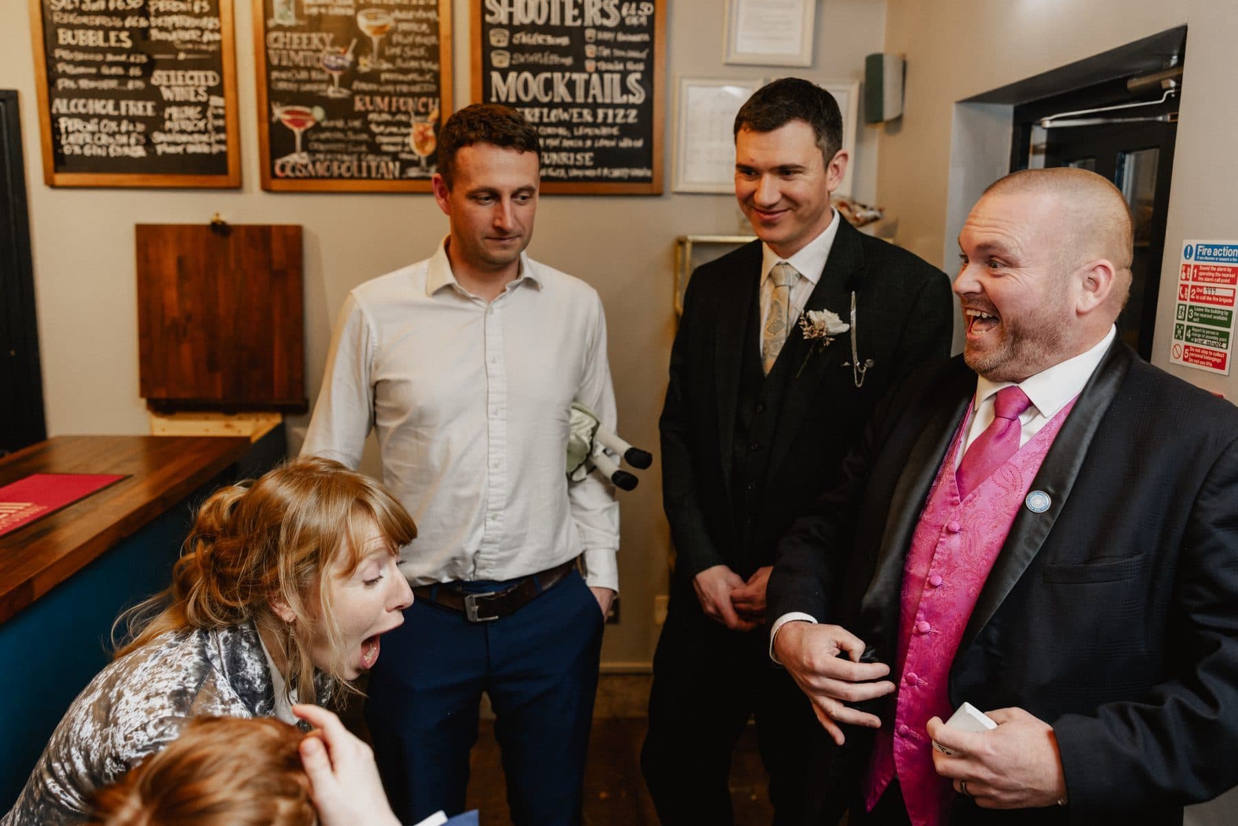 Happy wedding guests reacting to magic